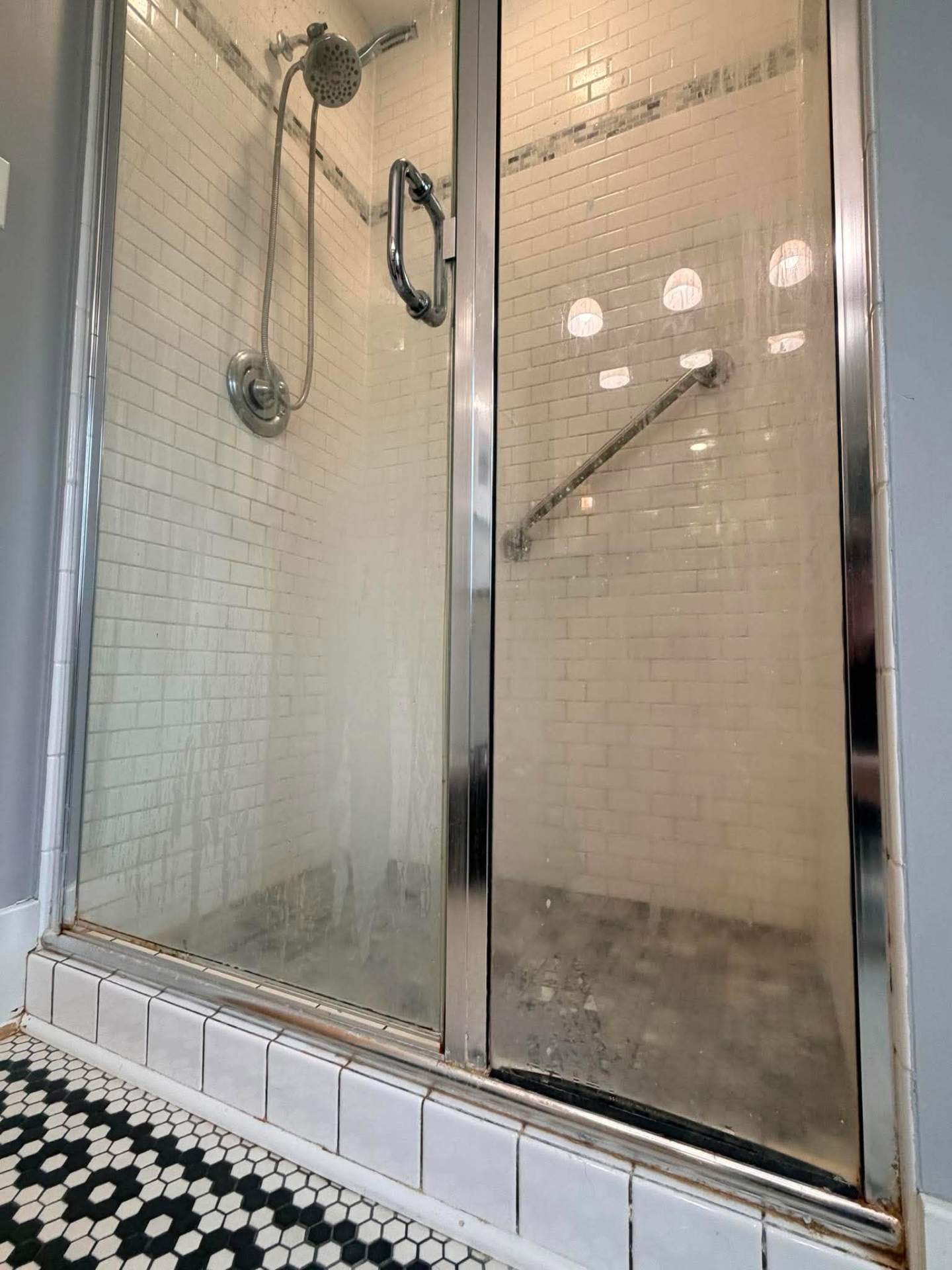 Shower glass and tile before cleaning